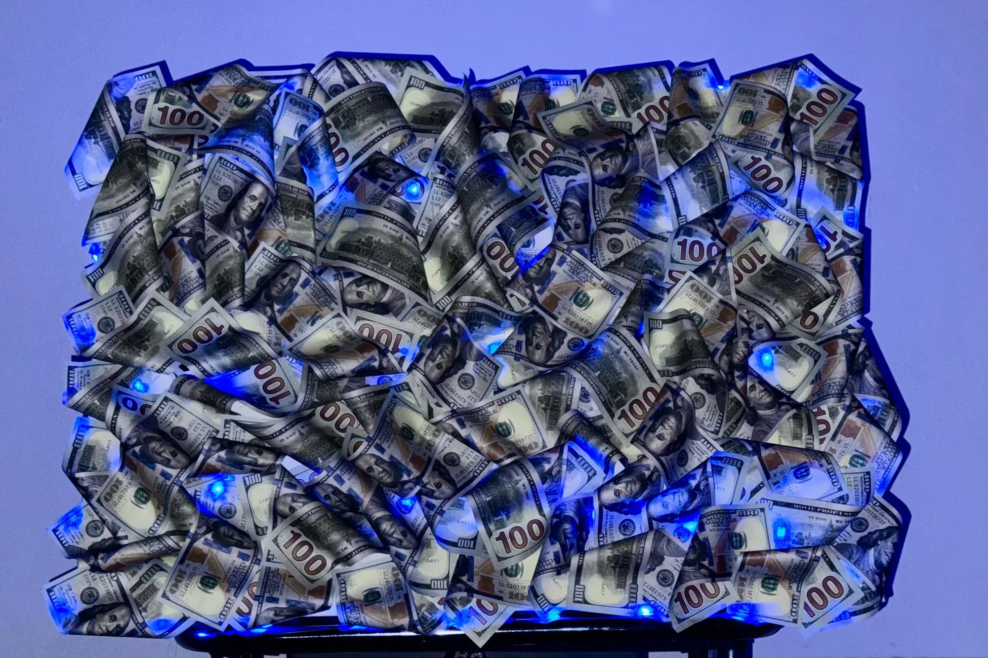 Photo of a 3D dollar bill painting at night – backlit with blue RGB LED