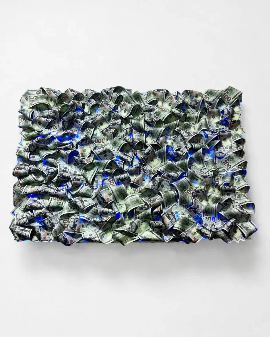 Photo of the 3D painting Cash Wave XL 70 × 100 cm made of dollar bills on a white wall with blue LED backlight